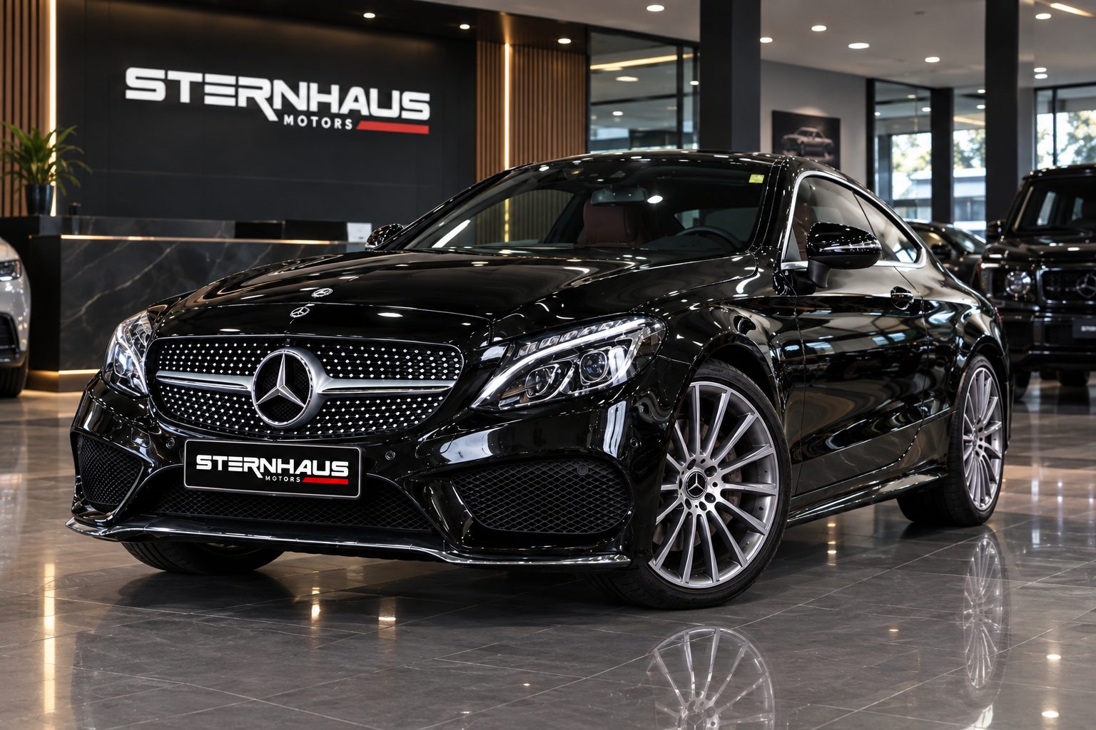 Black Mercedes-Benz C-Class coupe beside the Sternhaus Motors sign